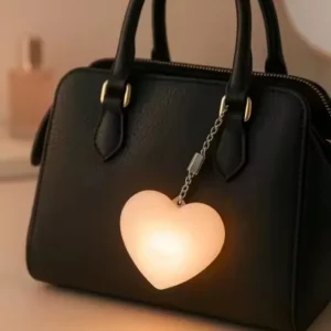 heart led keychain light glowing on handbag